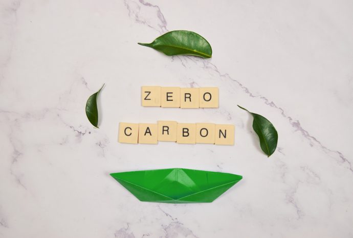 Net zero carbon neutral concepts net zero emissions with paper boat